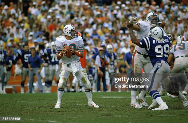 Dan Marino, quarterback for the Miami Dolphins, prepares to throw the football in a game against the Baltimore Colts.