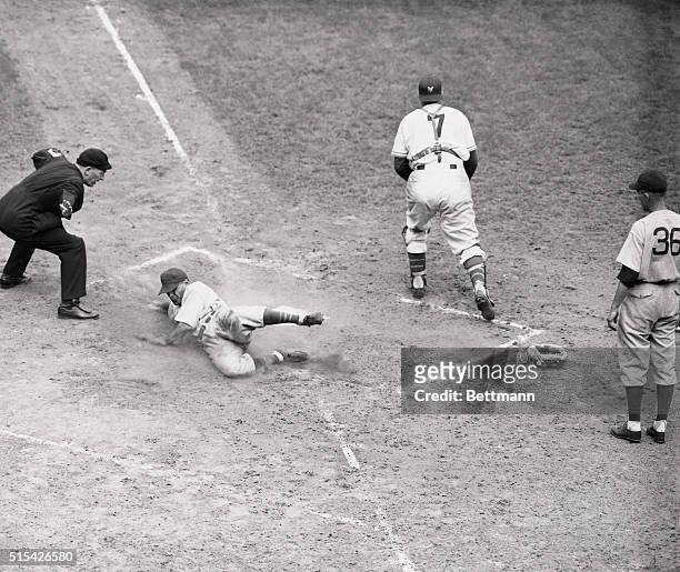 Nothing graceful about this slide, but Phil Cavarretta is safe as he brings home the Chicago Cubs' fifth run in the sixth inning of the New York...