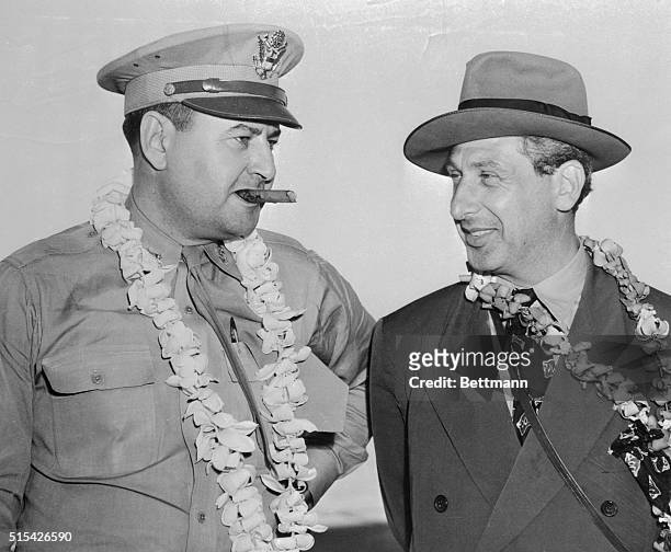 Meeting here while en route to the Able Day Atom Bomb Test at Bikini Atoll are Major General Curtis E. LeMay, cigar chewing Chief of the B-29 attacks...