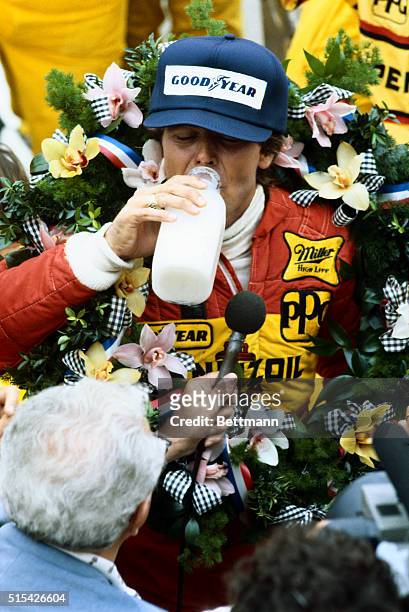Rick Mears is shown drinking from a bottle of milk in the Winner's Circle after winning the Indianapolis 500.