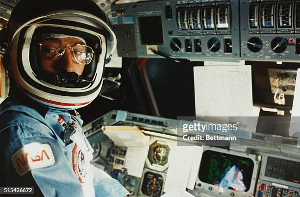 Earth Orbit - Commander John W. Young of the Space Shuttle mission STS-9 is at the commander's station ready for the re-entry of the Space Shuttle...