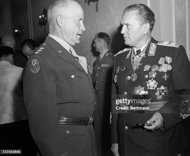 Lt. Gen. John C.H. Lee, Commanding General, Mtousa , has a serious conversation with Marshal Tito, attired in dress uniform and many medals, during a...