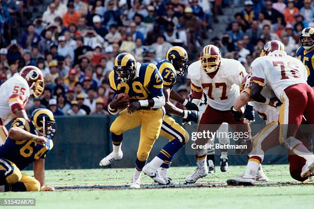 Eric Dickerson, halfback for the Los Angeles Rams, carrying the ball in a game against the Washington Redskins.