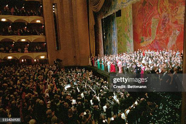 General view of the stage during the curtain call at the 100th Anniversary performance at the Metropolitan Opera. Frame shows stage crowded with...