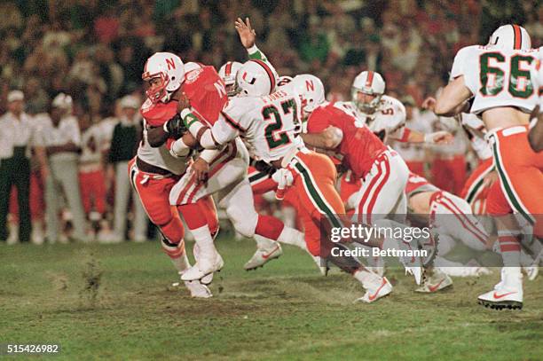 Heisman trophy winner Mike Rozier drives through the Miami Hurricanes defensive line during last quarter action at the 50th Orange Bowl Classic.