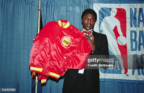 Hakeem Olajuwon, selected by the Houston Rockets 6/19 as first choice in the NBA draft, displays his new team jacket.