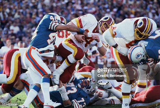 John Riggins of the Washington Redskins pushes through the Miami Dolphins defense.