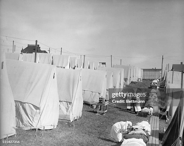 Photo shows a scene in the influenza Camp at Lawrence, Maine, where patients are given fresh air treatment. This extreme measure was hit upon as the...