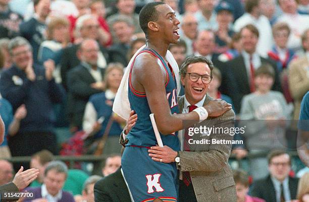 Pontiac, Mich.: Kansas Coach Larry Brown hugs Danny Menning after Kansas defeated Kansas State 71-58, to advance to the "Final Four". Manning was...