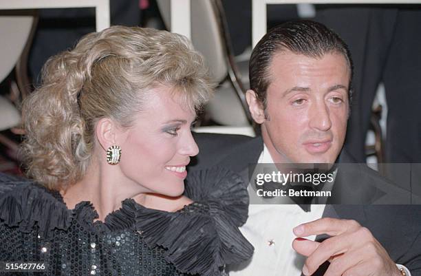 Game show hostess Vanna White and her "date" movie star Sylvester Stallone pose for photographers during the Annual Dinner of the White House...