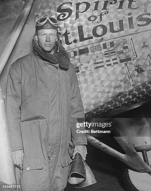 Colonel Charles A. Lindbergh standing in front of his plane Spirit of St. Louis upon his arrival in St.. Louis, Missouri, at the completion of his...