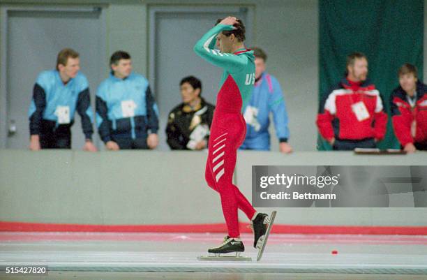 World sprint speed skating champion Dan Jansen of the United States holds his head moments after crashing in the 500 meters and being disqualified...