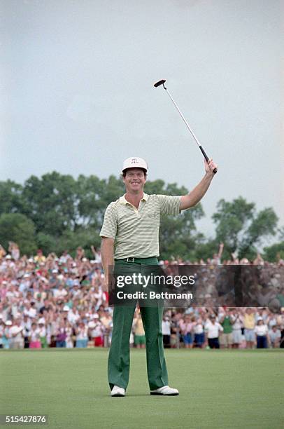 Oak Brook, Illinois: Tom Watson raises his putter in jubilation after sinking a 25-ft. Birdie putt on the third sudden death playoff hole to edge...