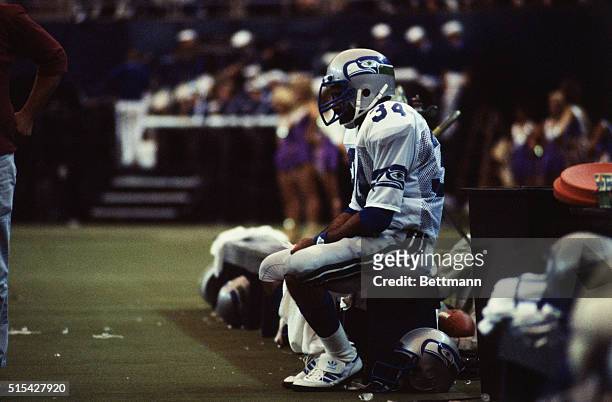 Franco Harris of the Seattle Seahawks sitting on the sidelines during a game.