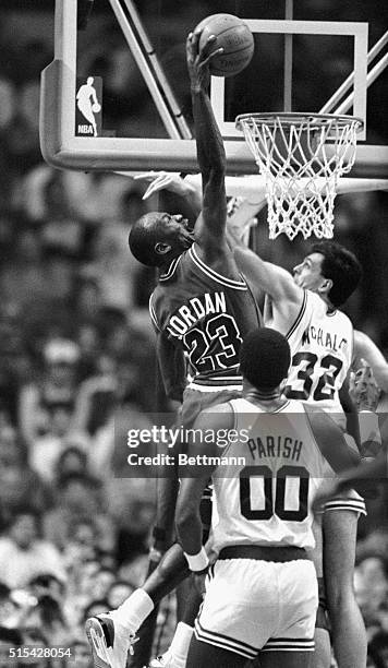 Chicago Bulls' Michael Jordan gets set to stuff ball over Celtics' Kevin McHale during 3rd quarter action of game at Boston Garden, 3/20. Boston won...