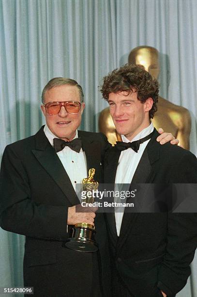 Gene Kelly and son Tim with replacement Oscar.
