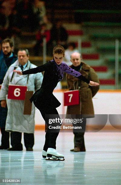 East German figure skating Katerina Witt performs her compulsory figures under the watchful eyes of the judges behind her here today.