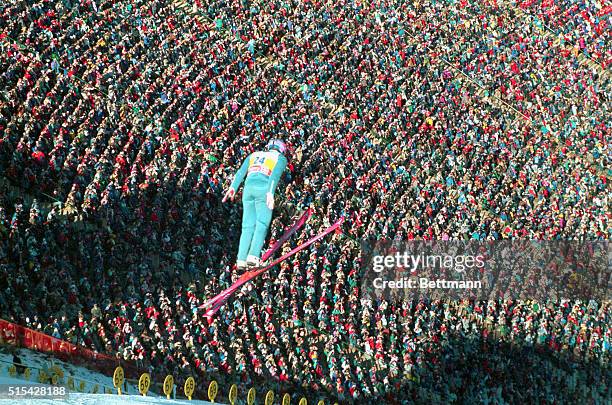 Eddie "The Eagle" Edwards soars over the crowd as he makes his second jump of the day during the 90 meter ski jump competition today. Edwards,...