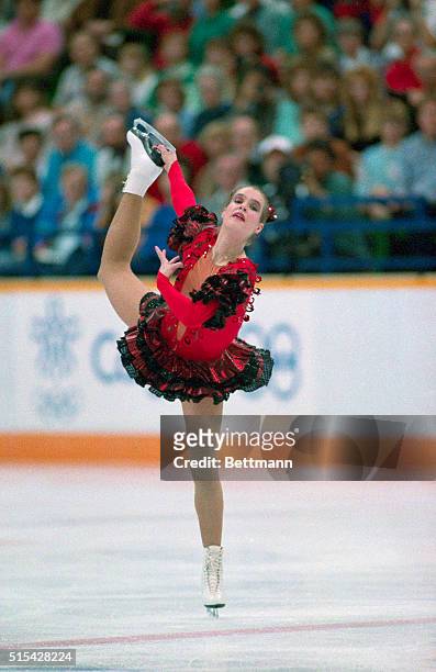 East Germany's Katarina Witt holds her skate as she skates her way to a gold medal with her performance in the women's long program in the Saddledome...
