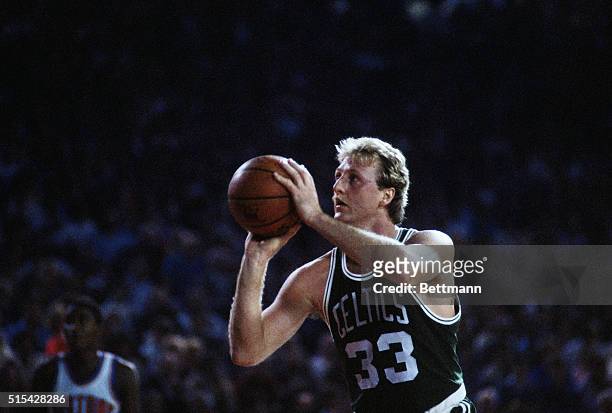 Boston Celtics forward Larry Bird shoots a free throw during a game against the Detroit Pistons at the Pontiac Silverdome in Pontiac, Michigan.