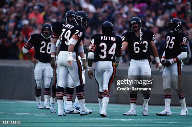 Walter Payton is shown amongst the Chicago Bears gathered on the field during a football game with the New Orleans Saints.