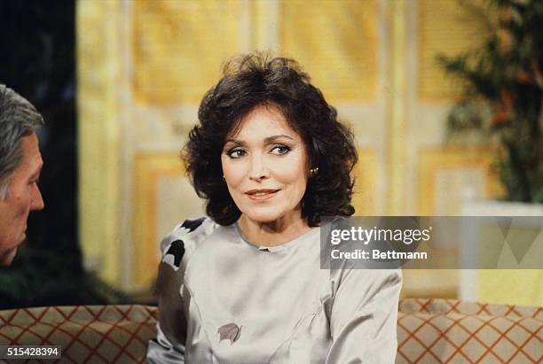 The estranged wife of television personality Johnny Carson, Joanna Carson, being interviewed on a talk show.