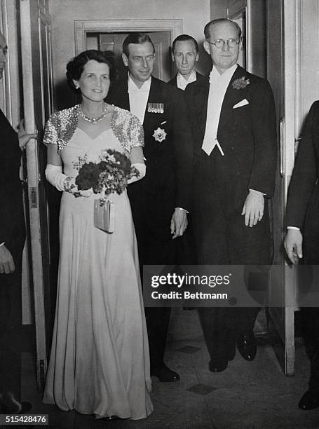 The Duke of Kent, brother of King George of England, is shown with Mrs. Joseph Kennedy and her husband, the United States Ambassador to Great...