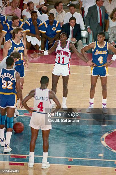 Best of friends both on and off the court, Detroit Pistons Isiah Thomas gestures to Los Angeles Lakers Magic Johnson after the two had a pushing...