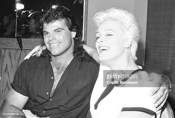 Uniondale, N.Y.: New York Jet's Mark Gastineau and actress Brigitte Nielsen announce their engagement and seal it with a kiss during a press...