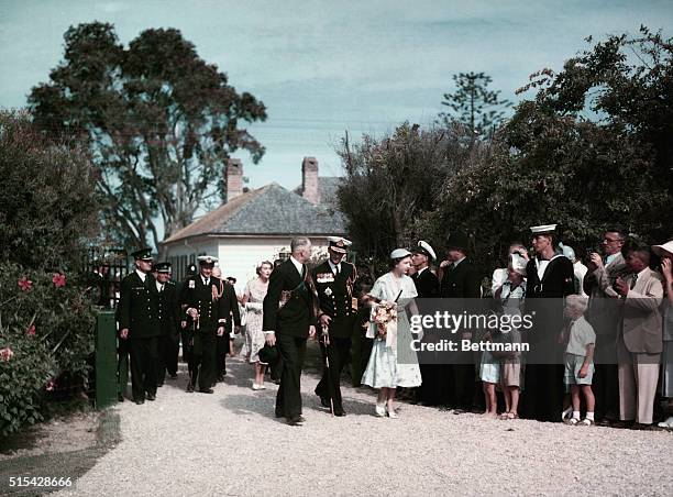 Queen Elizabeth II is shown here on a Royal Tour. The Queen is leaving the Treaty House in Waitangi. She is accompanied by Prince Phillip and her...