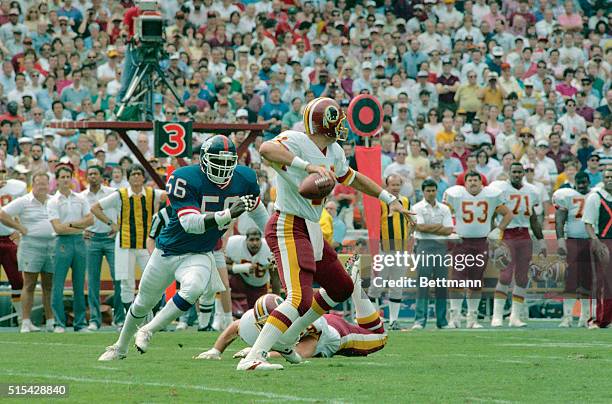 New York Giants linebacker Lawrence Taylor rushes Washington Redskins quarterback Mark Rypien during first half action 10/2 at RFK Stadium. The...