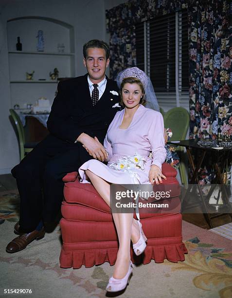 Ben Gage and Esther Williams are shown seated after their wedding ceremony in Westwood Hills Congregational Church. Miss Williams carried, for...