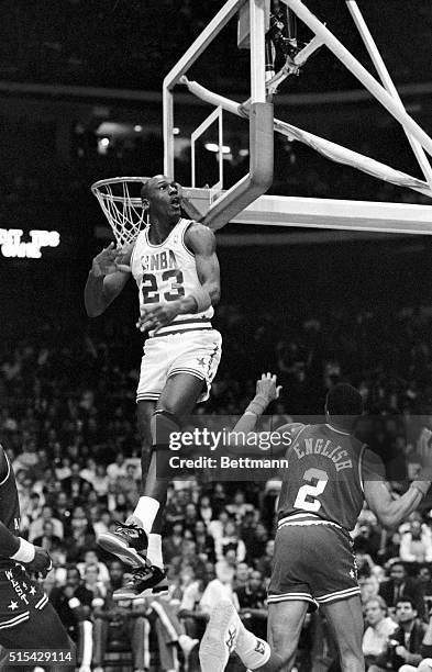 Bulls' Michael Jordan watches the flight of the ball into the audience after he blocked a shot by Alex English early in the first quarter of the 38th...