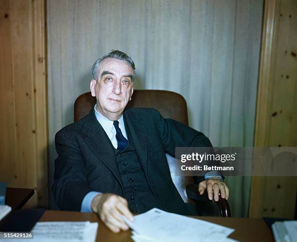 Secretary of the Treasury Fred Vinson is shown seated at a desk in this waist-up portrait.