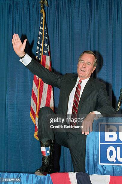 Houston; Vice-President George Bush displays a pair of "Texas Flag" cowboy boots at Republican Victory 88 conference in Houston.