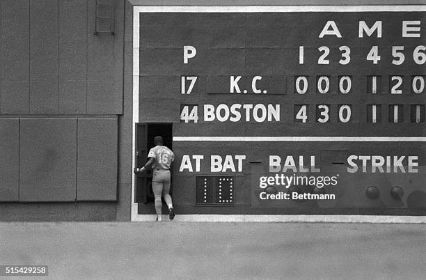 Royal's left fielder Bo Jackson takes refuge from the near 110-degree heat and the Red Sox by ducking behind the scoreboard on Fenway Park's Green...