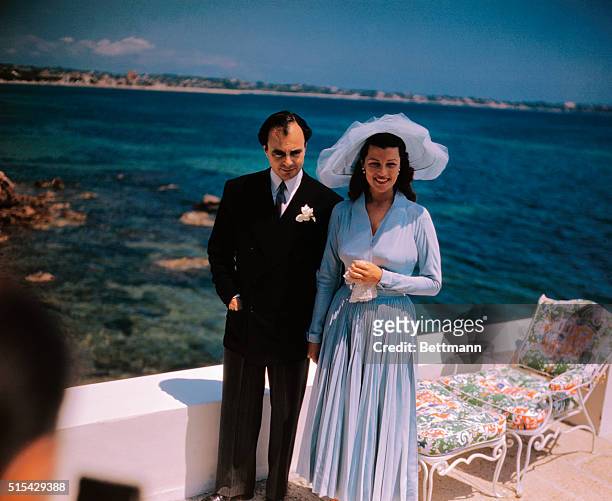 The wedding reception of Prince Aly Khan and Rita Hayworth was held at the Chateau De L'Horizon. Here they pose for photo.