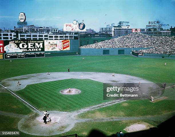 Photo shows baseball action in Boston's Fenway Park. The pitcher has just thrown the ball.