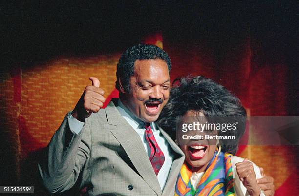 Atlanta, Georgia: Jesse Jackson gives a "thumbs up" sign as he enjoys his appearance on stage with an equally happy Oprah Winfrey at a salute for...