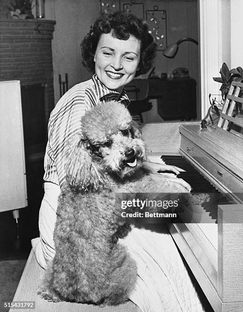 Poodle with a penchant for the piano, 'Danny' joins comedienne Betty White for some close harmony at the keyboard. Betty has two other dogs, a...