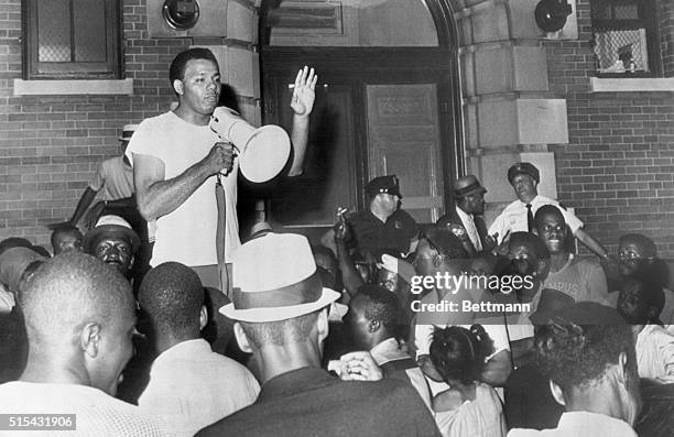 Robert Curvin, CORE official, uses bullhorn to ask crowd to calm down as they gather in front of the Fourth Precinct Police station during the Newark...