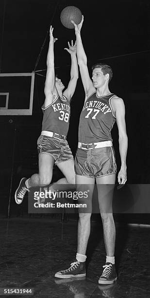 Bob Watson, Kentucky guard, leaps in vain attempt to take the ball away from Bill Spivy during a practice session at Madison Square Garden in...