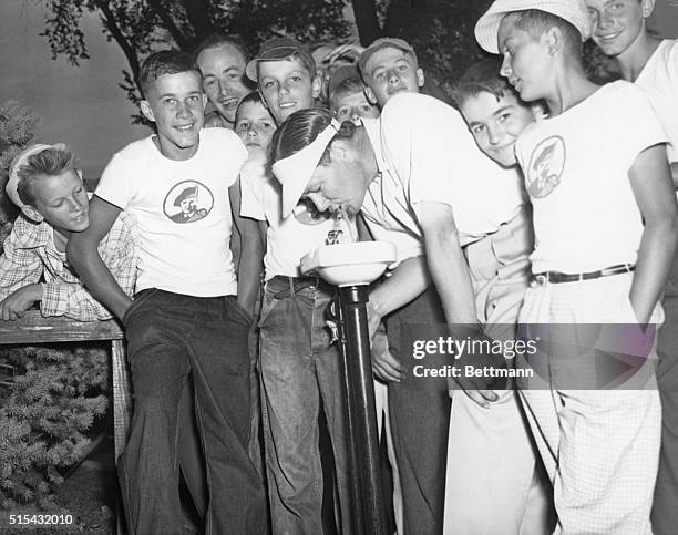 Byron Nelson, leader of the field in today's play at the Tam O'Shanter All-American, by virtue of his score of 138, stops at a nearby drinking...