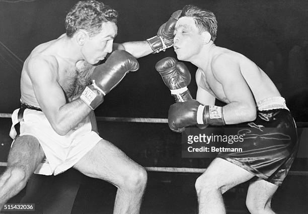 Willie Pep flattens his glove in the face of Fabela Chavez during the sixth round of their featherweight bout in St. Louis. Pep took a unanimous...