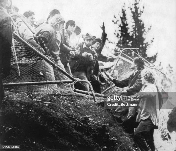 Anti-apartheid demonstrators pull down a fence surrounding the football park during the first game of the touring South Africa rugby team against...