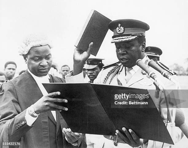 Kampala, Uganda- Major-General Idi Amin, the leader of last month's successful military coup, takes the oath of office under the supervision of Chief...