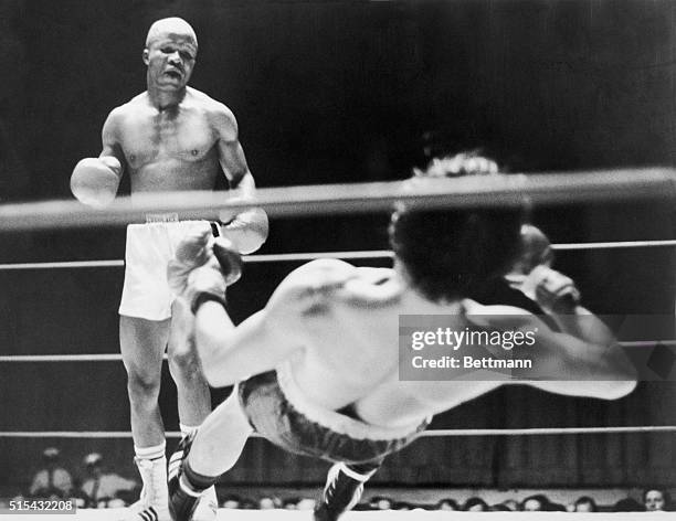 Boxer Alberto Jangalay is felled by a left hook from Kid Snowball during the eighth round of their bantam weight match. Jangalay got to his feet...