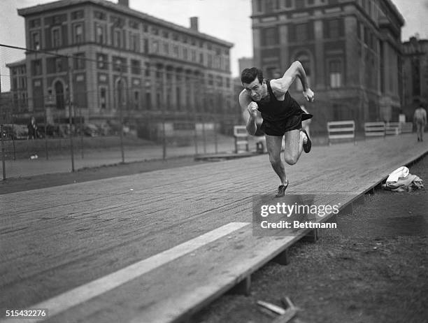 Louis Zamperini, University of Southern California track star, runs with old Father Time as an opponent during workout at South Field, Columbia...