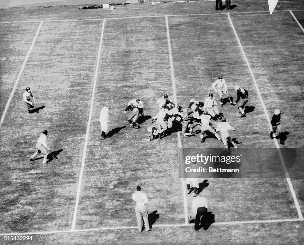 The University of Georgia, players breaking through the Yale line during a stirring game here. This first venture of the Yale team across the...