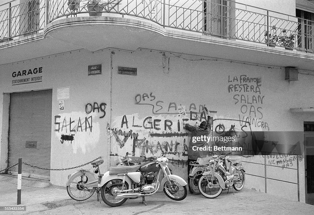 Man Writes French OAS Grafitti on Wall